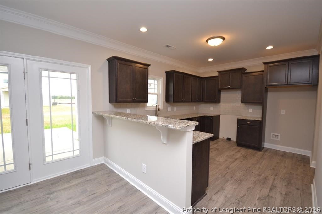 5219 Riva Ridge Lane Hope Mills, NC 28348 - Photo 11 of 27 a kitchen with stainless steel appliances granite countertop a sink a stove and a refrigerator