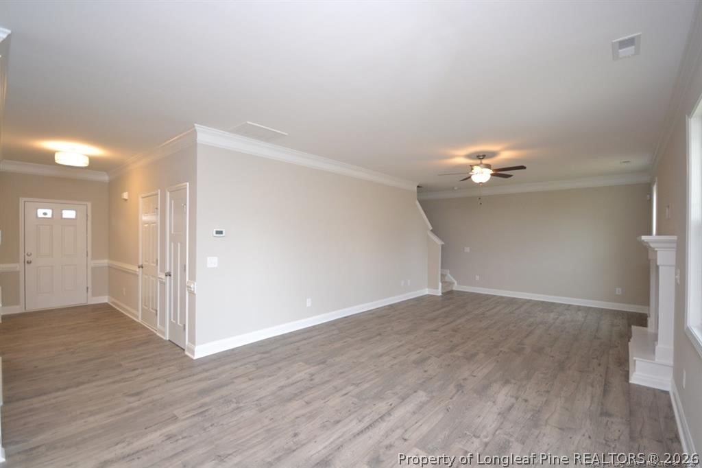 5219 Riva Ridge Lane Hope Mills, NC 28348 - Photo 13 of 27 an empty room with wooden floor and ceiling fan