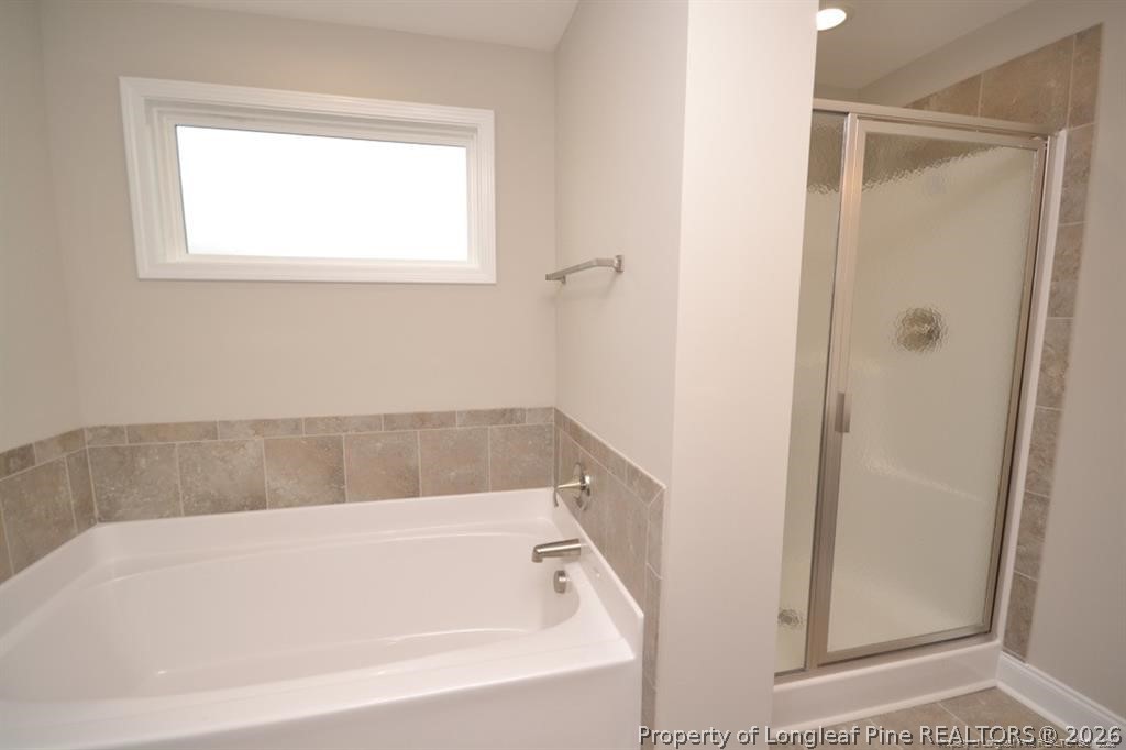 5219 Riva Ridge Lane Hope Mills, NC 28348 - Photo 16 of 27 a white bath tub sitting next to a window