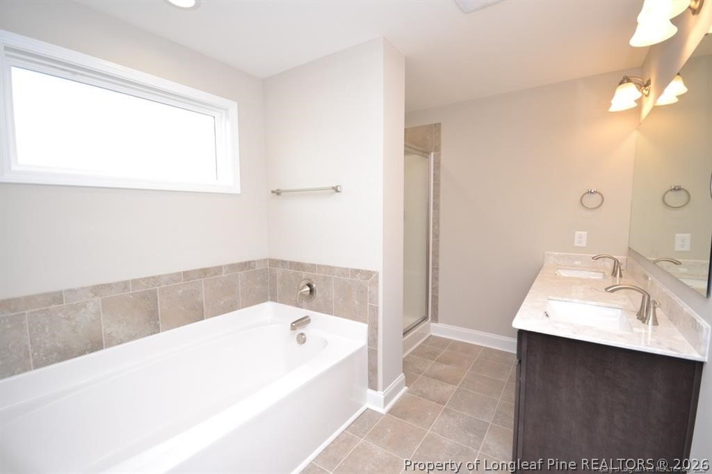 5219 Riva Ridge Lane Hope Mills, NC 28348 - Photo 17 of 27 a bathroom with a bathtub and a sink