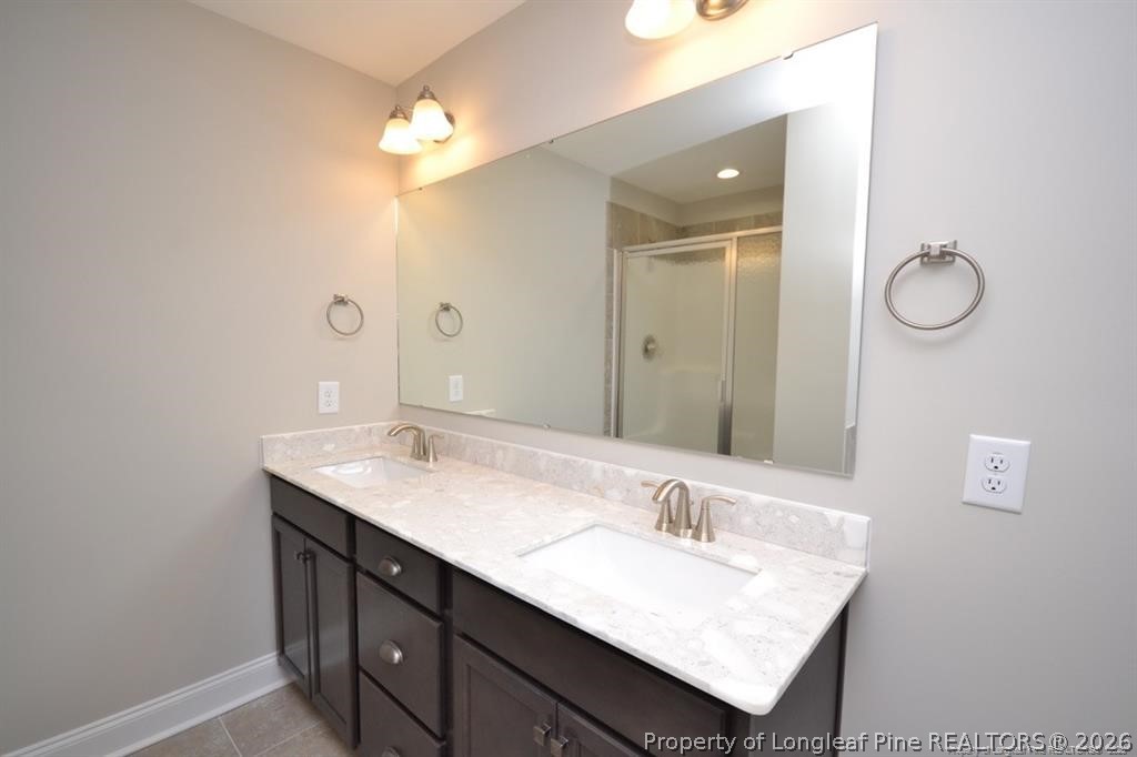 5219 Riva Ridge Lane Hope Mills, NC 28348 - Photo 18 of 27 a bathroom with a sink vanity and a mirror