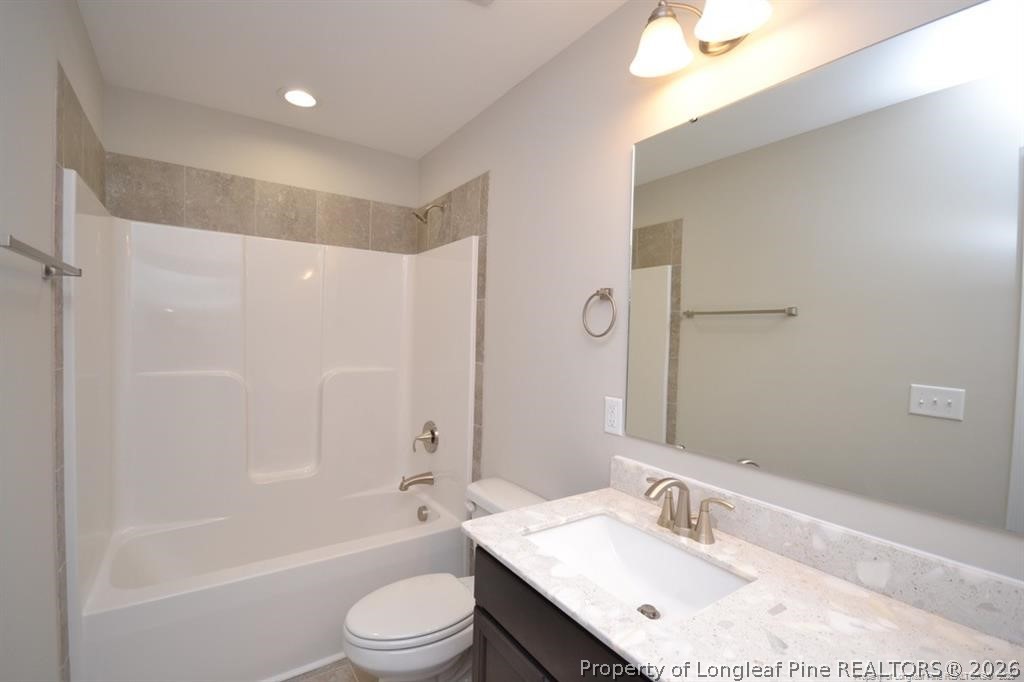 5219 Riva Ridge Lane Hope Mills, NC 28348 - Photo 22 of 27 a bathroom with a bathtub shower sink vanity mirror and toilet
