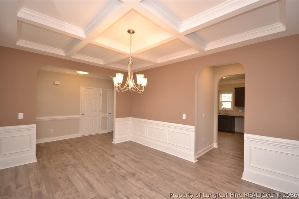 5219 Riva Ridge Lane Hope Mills, NC 28348 - Photo 7 of 27 an empty room with wooden floor and chandelier