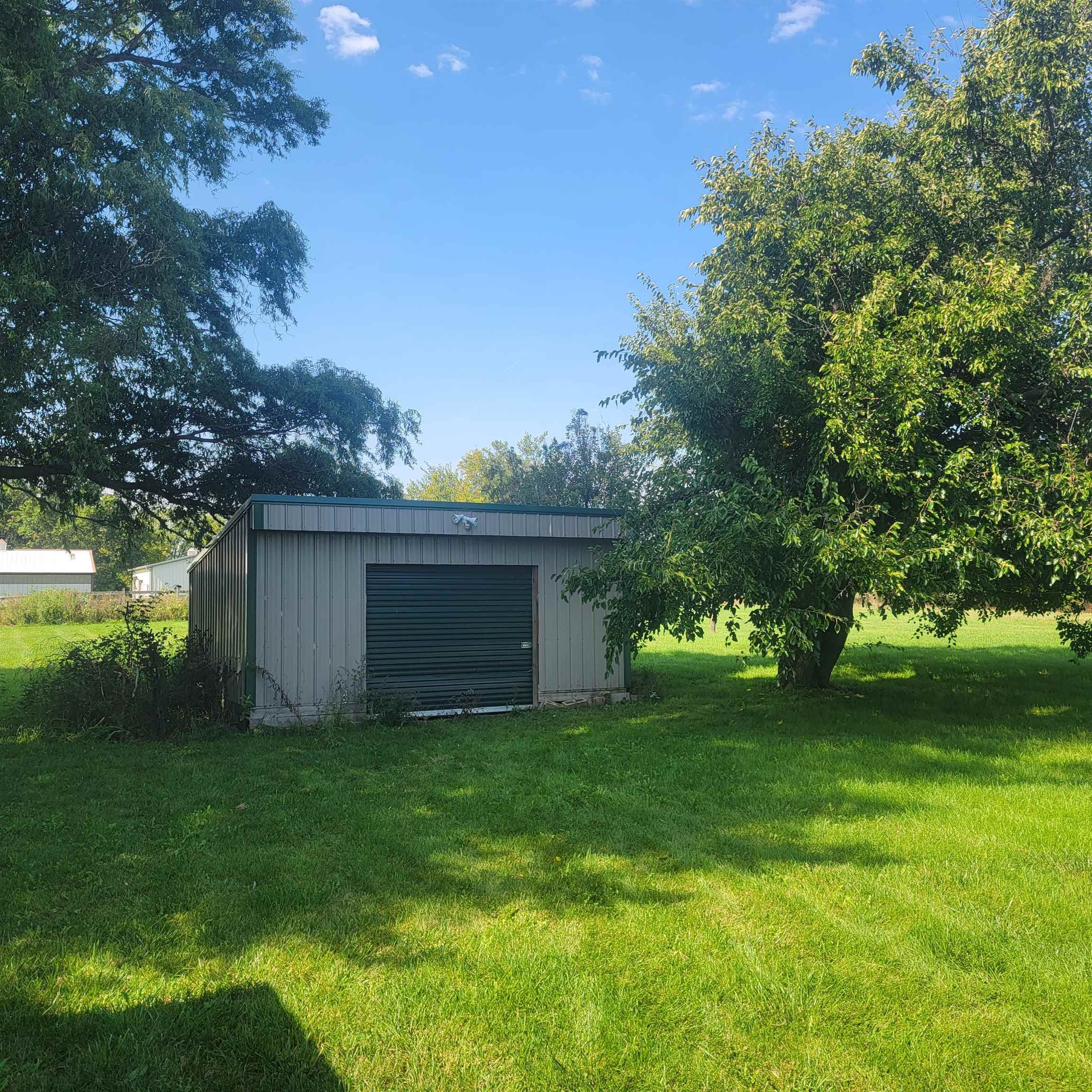 6641 Halley Road Rockford, IL 61101 - Photo 3 of 13 a view of a backyard with plants and large trees