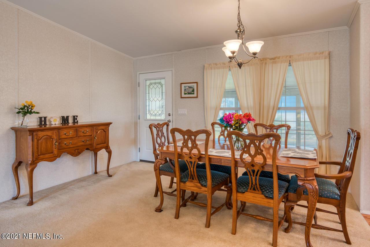 279 Pizarro Road St. Augustine, FL 32080 - Photo 11 of 34 a dining room filled chandelier and wooden furniture