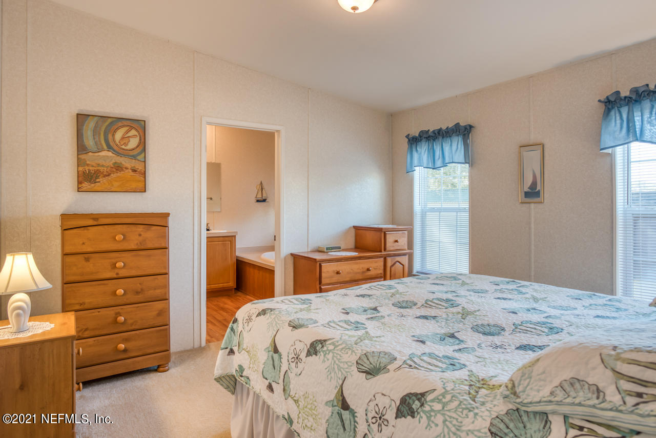 279 Pizarro Road St. Augustine, FL 32080 - Photo 19 of 34 a bedroom with a bed and a dresser