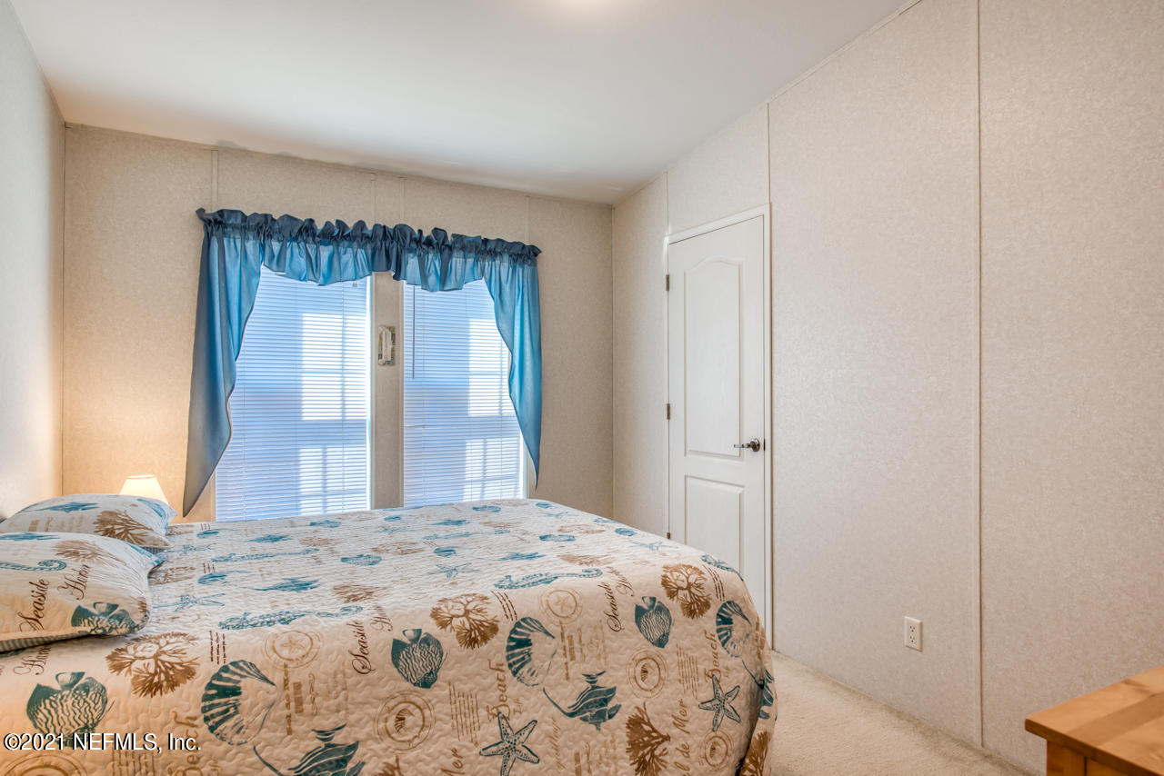 279 Pizarro Road St. Augustine, FL 32080 - Photo 24 of 34 a bedroom with a large bed and a window