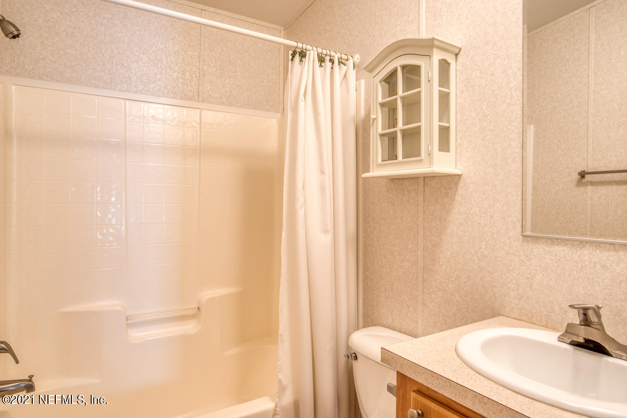 279 Pizarro Road St. Augustine, FL 32080 - Photo 25 of 34 a bathroom with a sink a toilet and a mirror