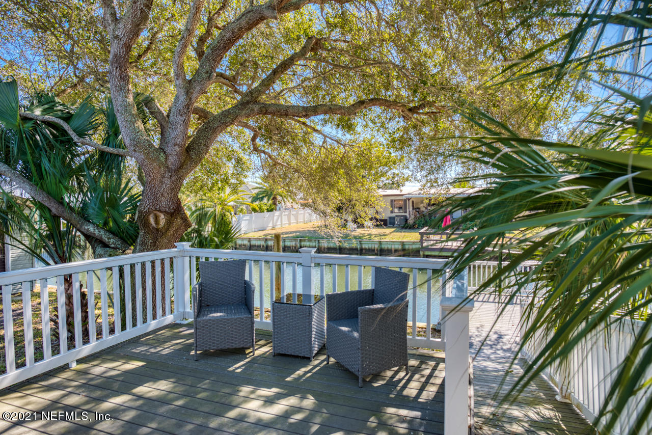 279 Pizarro Road St. Augustine, FL 32080 - Photo 8 of 34 a view of a deck in the backyard with large trees and barbeque oven
