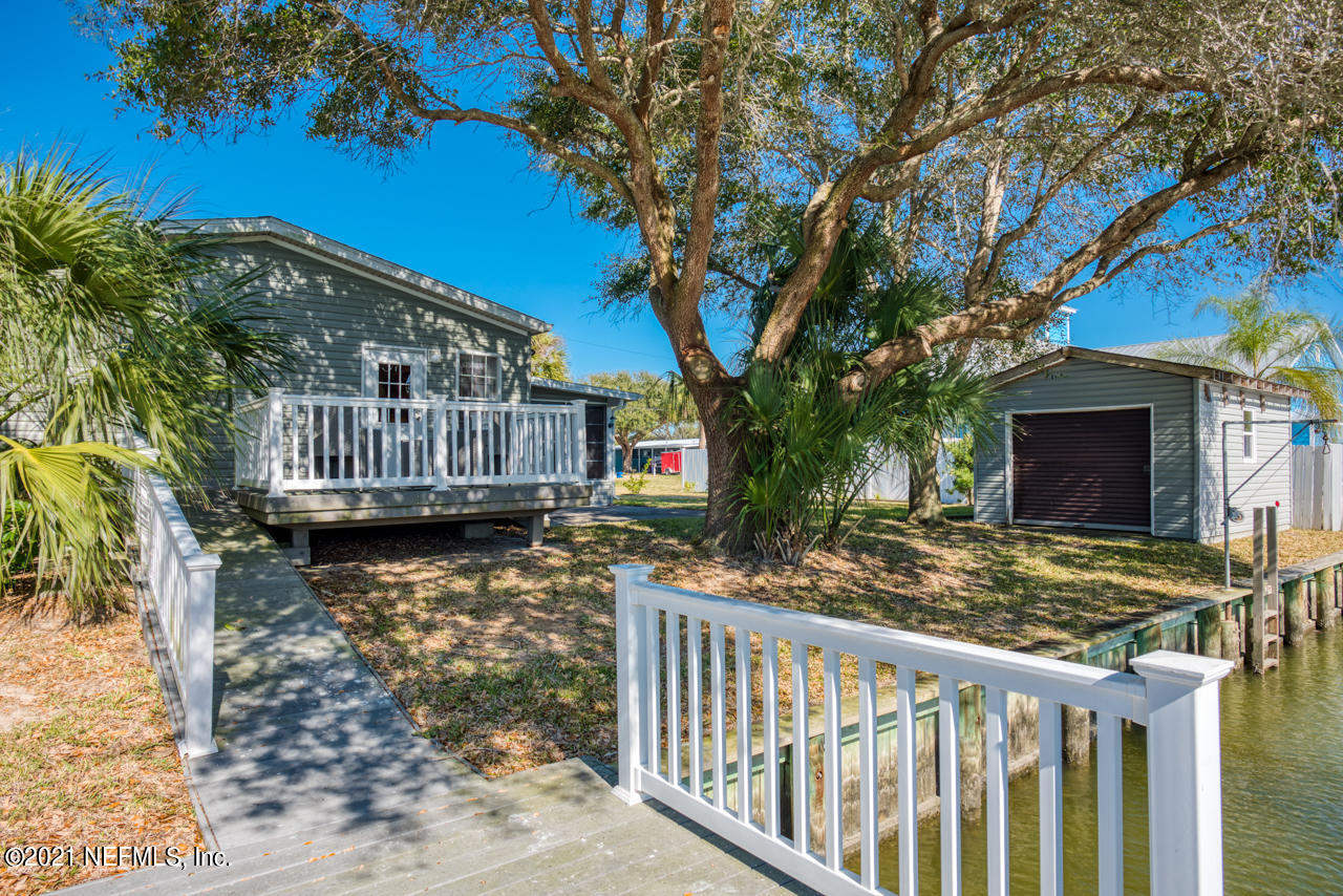 279 Pizarro Road St. Augustine, FL 32080 - Photo 9 of 34 a view of a house with a small yard next to a road