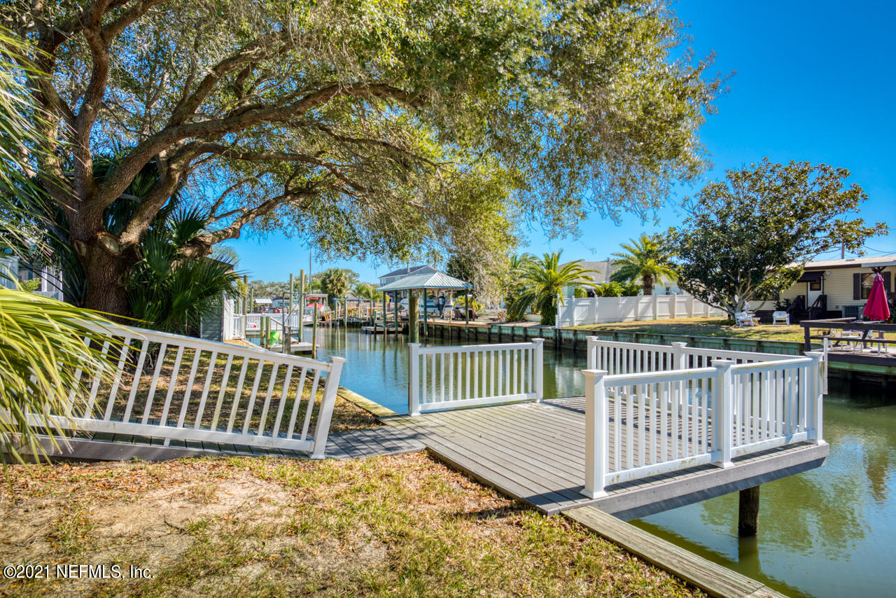 279 Pizarro Road St. Augustine, FL 32080 - Photo 10 of 34 a view of a deck with a white roof and fence