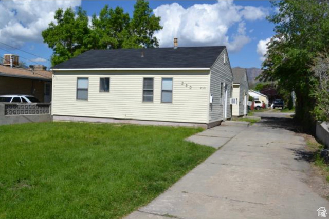 230 North 2nd Street Tooele, UT 84074 - Photo 1 of 18 Single-story residence featuring light-colored siding, a dark shingle roof, and a front lawn