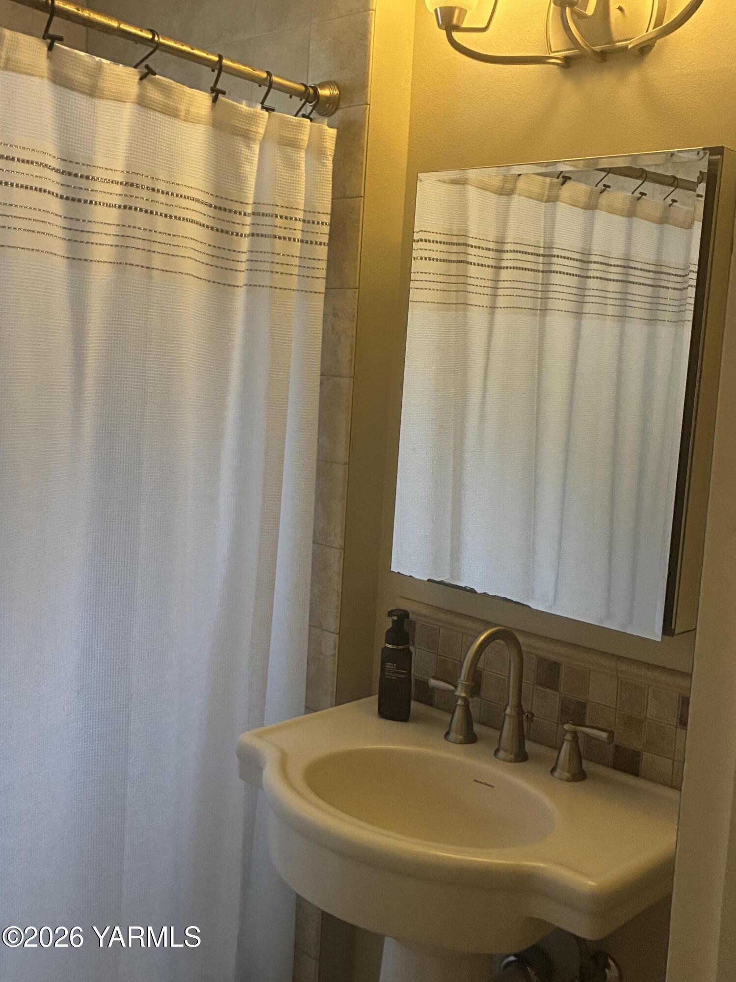 303 Ave G Grandview, WA 98930 - Photo 12 of 23 a bathroom with a sink and a mirror