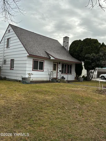 a front view of a house with swimming pool having outdoor seating