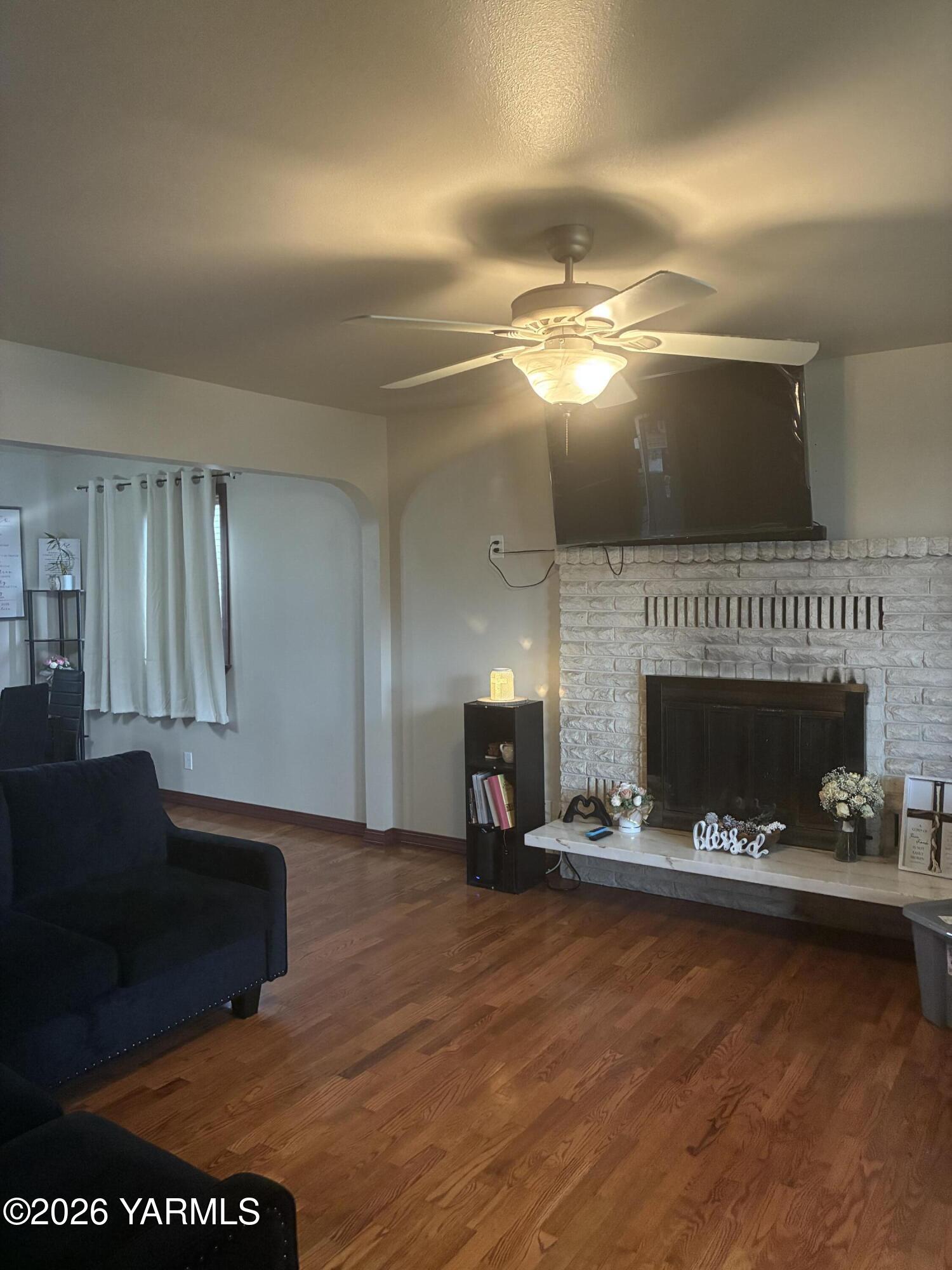 303 Ave G Grandview, WA 98930 - Photo 4 of 23 a living room with furniture and a fireplace