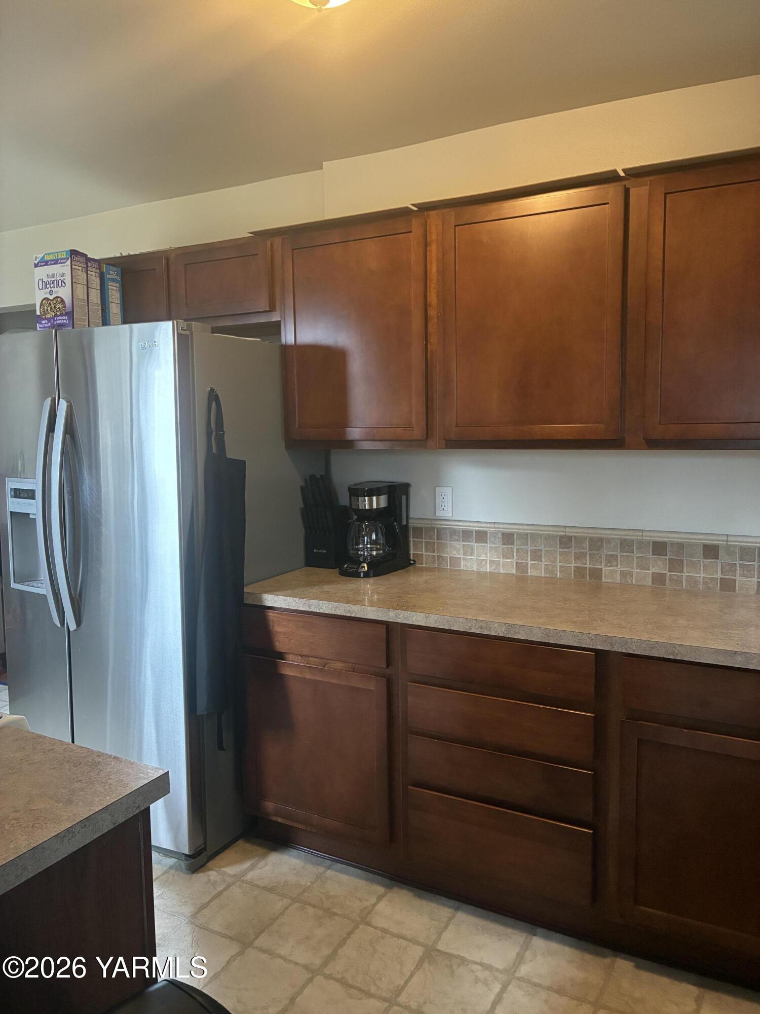 303 Ave G Grandview, WA 98930 - Photo 7 of 23 a kitchen with stainless steel appliances granite countertop a refrigerator and a sink