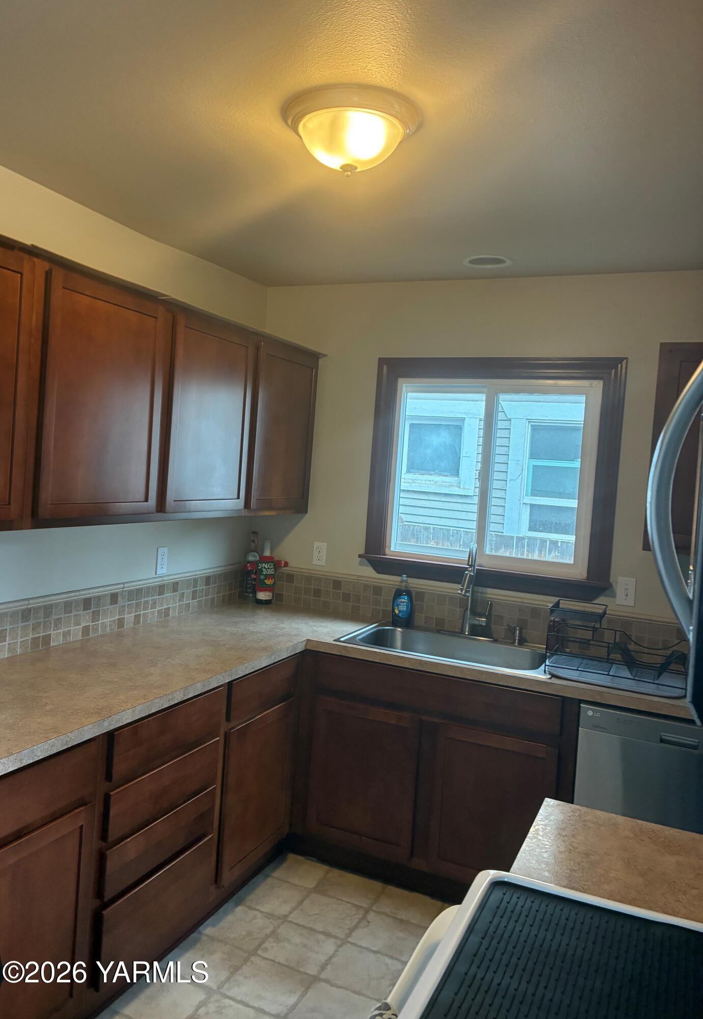 303 Ave G Grandview, WA 98930 - Photo 8 of 23 a kitchen with a sink and cabinets