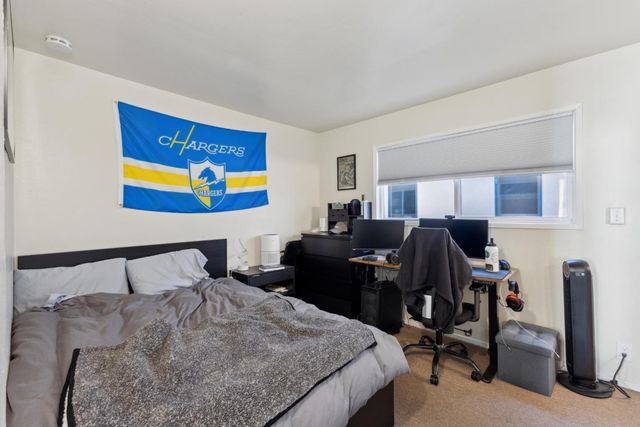 a bedroom with a bed and a chair