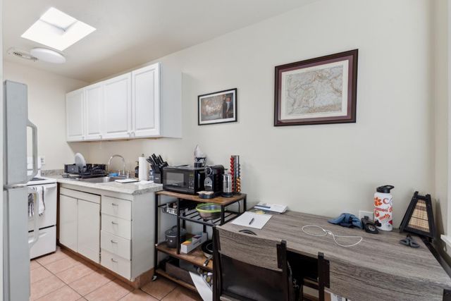a kitchen with stainless steel appliances granite countertop a stove and a refrigerator