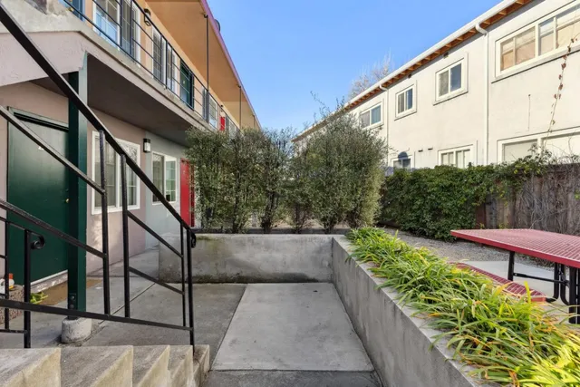 a porch with a table and chairs