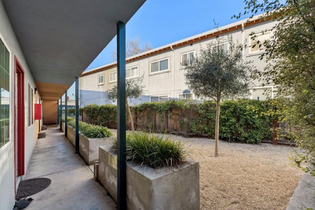 a backyard of a house with table and chairs