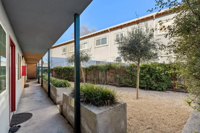 a backyard of a house with table and chairs
