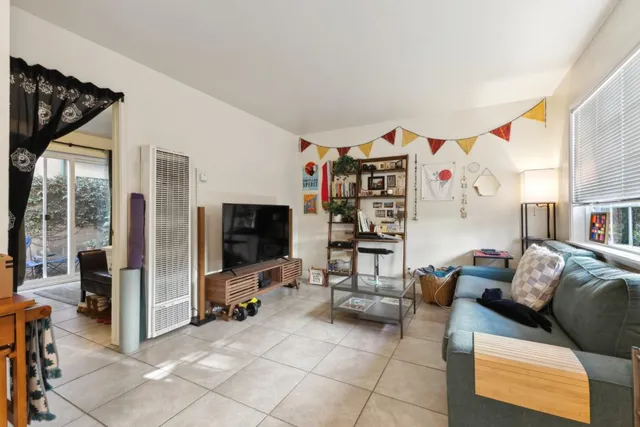 a living room with furniture and a kitchen view