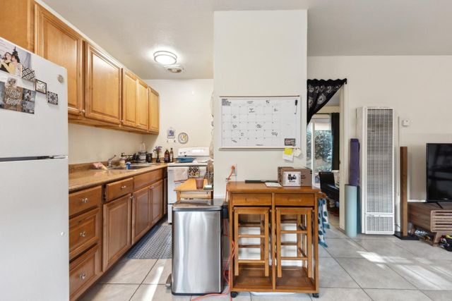 a view of a workspace with furniture and a flat screen tv