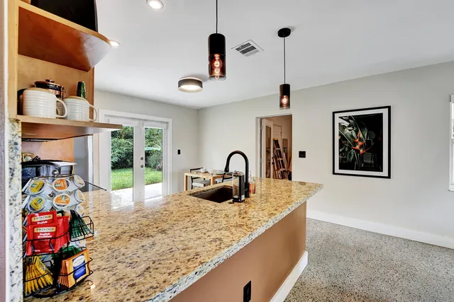 a kitchen with stainless steel appliances granite countertop a sink and a stove