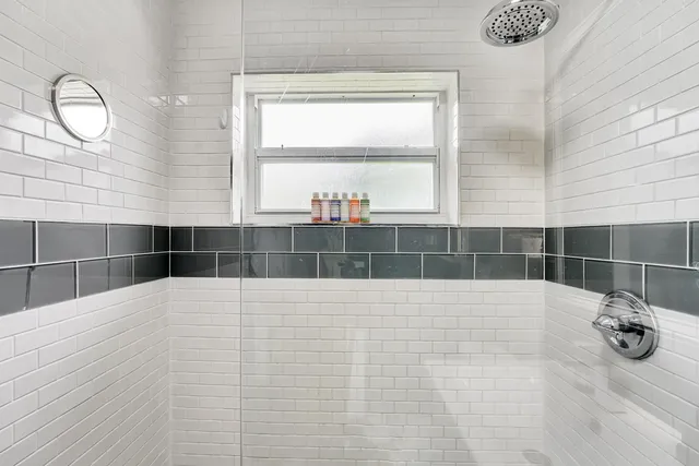 a bedroom with a bed couch and a window