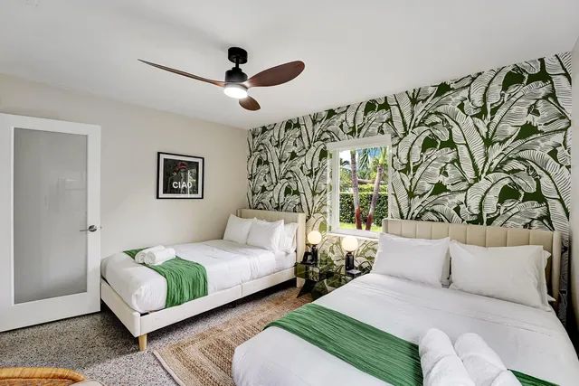 a bedroom with a bed and a painting on the wall