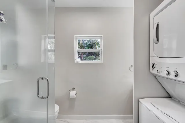 a bathroom with a shower and toilet