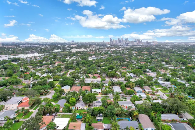 an aerial view of residential houses with city view