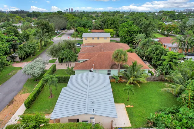 an aerial view of a house with yard