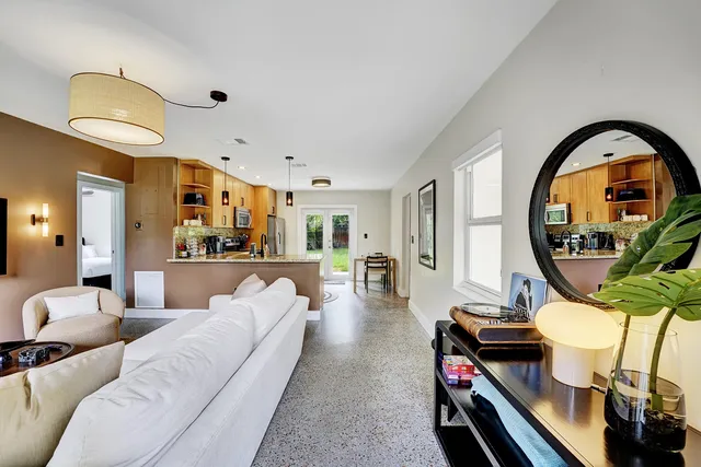 a living room with furniture and a mirror