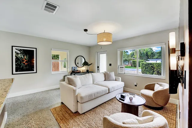 a living room with furniture and a large window