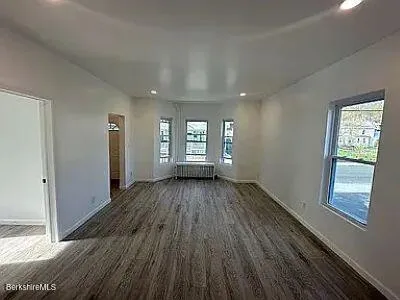 wooden floor in an empty room with a window