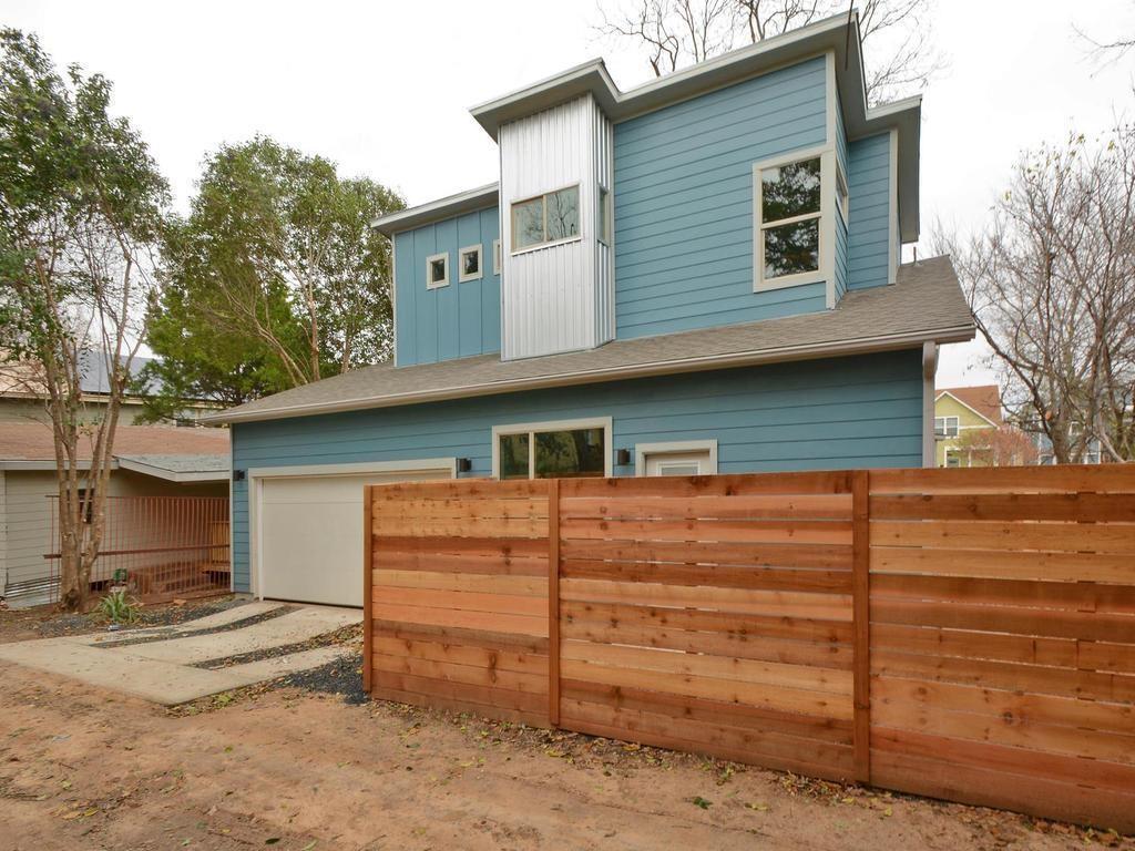 1608 Miriam Avenue, Unit B Austin, TX 78702 - Photo 9 of 10 View of front of home featuring a garage, board and batten siding, driveway, and a shingled roof