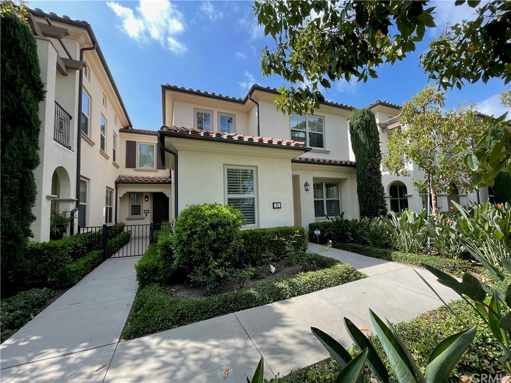 a front view of a house with garden and plants