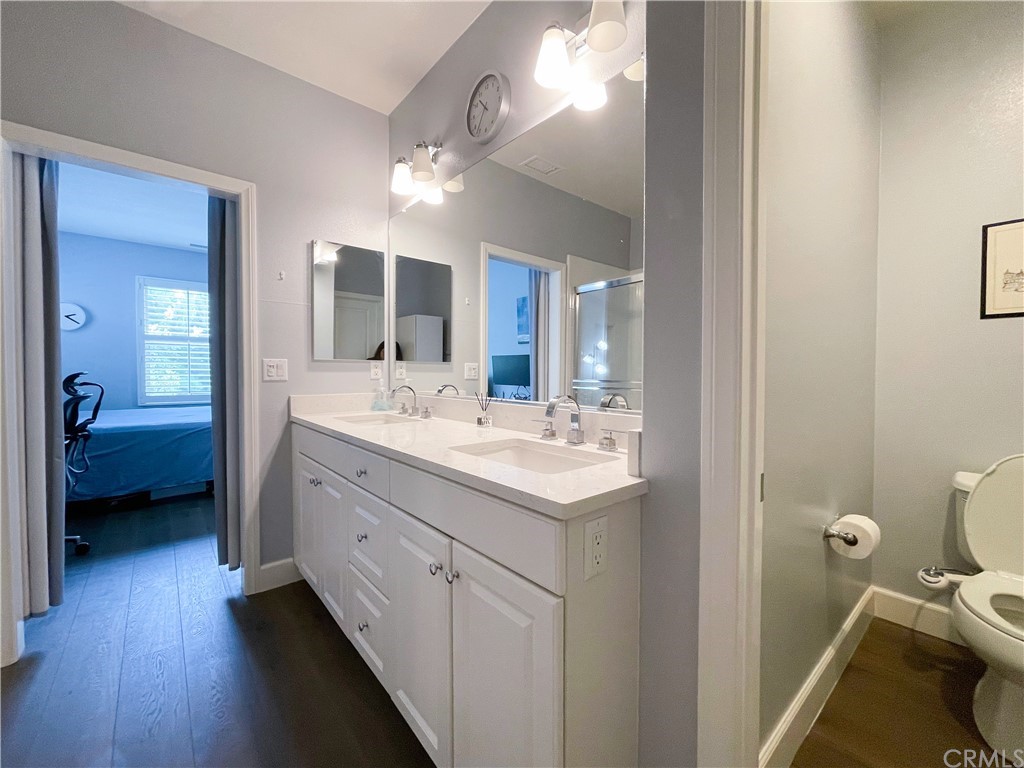 35 Courant Irvine, CA 92618 - Photo 20 of 21 a en suite bathroom with a double vanity sink a mirror and a toilet