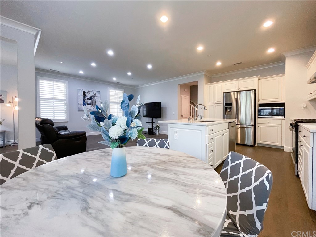 35 Courant Irvine, CA 92618 - Photo 7 of 21 a kitchen with sink refrigerator dining table and chairs