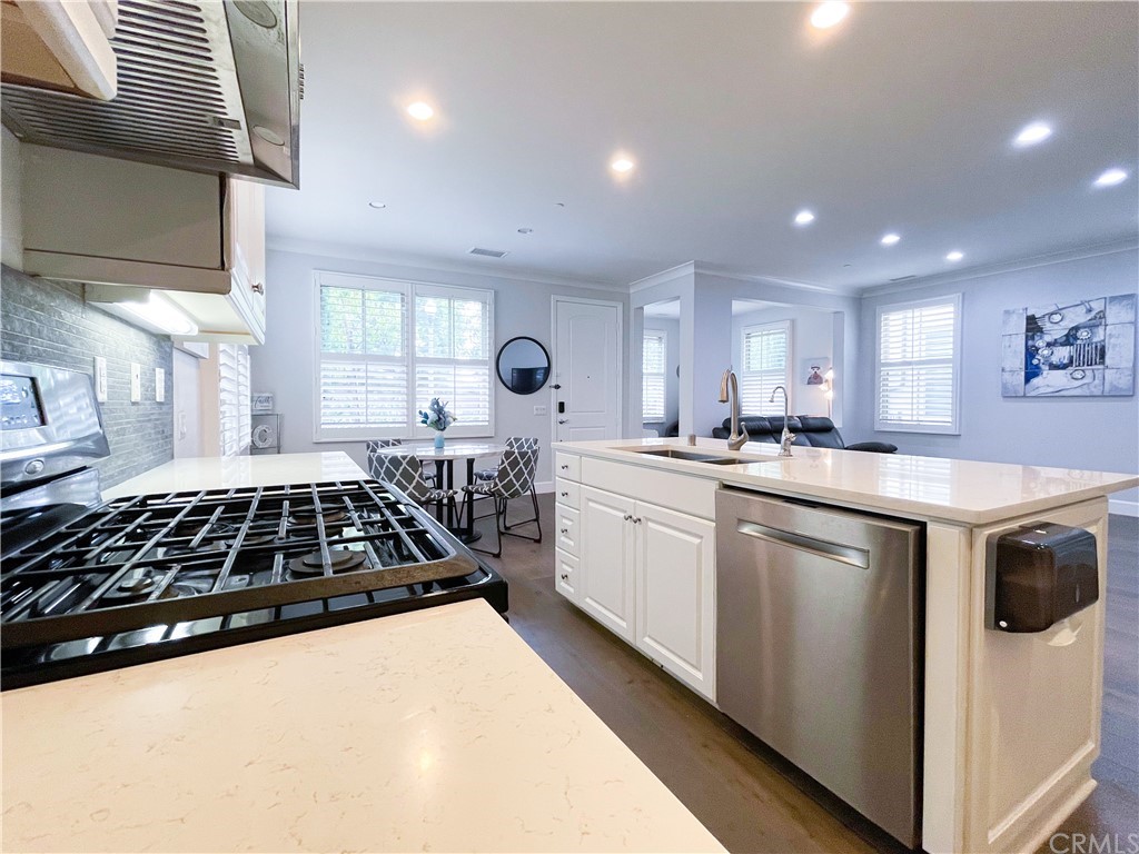 35 Courant Irvine, CA 92618 - Photo 10 of 21 a kitchen with a stove a sink a microwave and cabinets