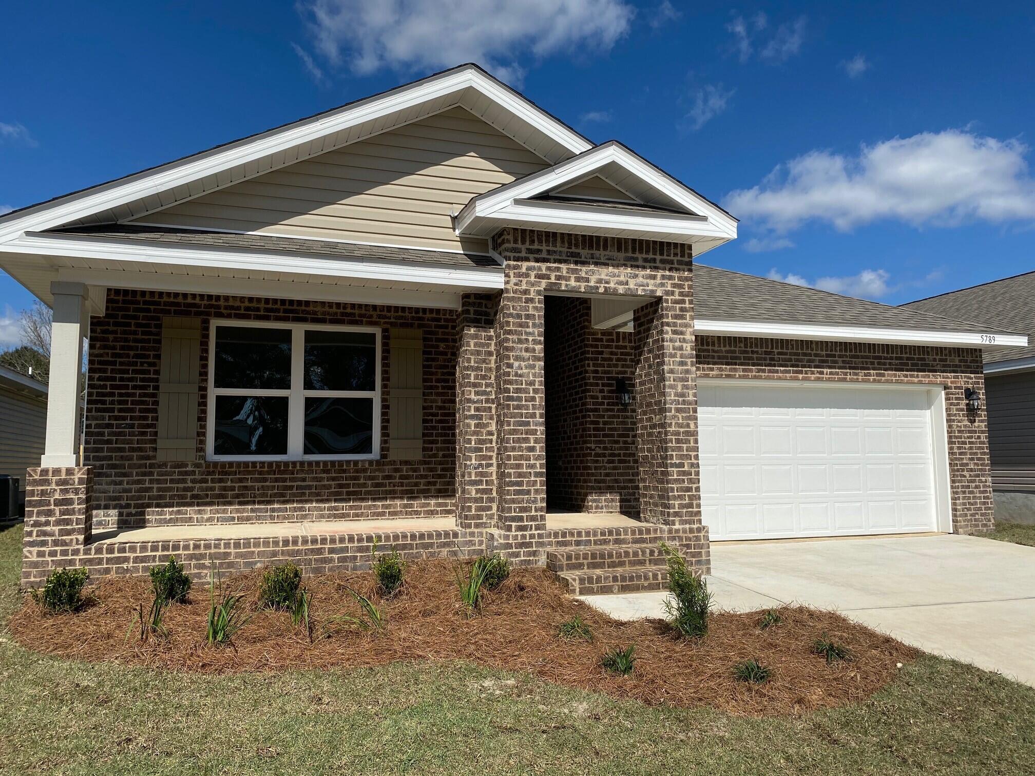 4725 Airmen Drive Crestview, FL 32539 - Photo 2 of 38 a front view of a house with garden