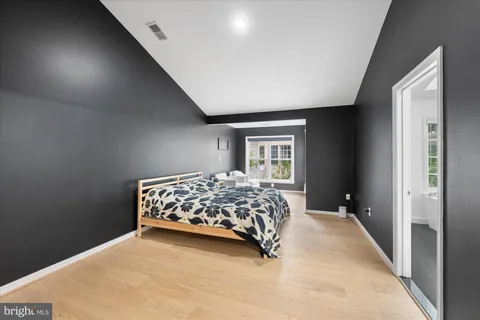 a bedroom with a large bed and a window