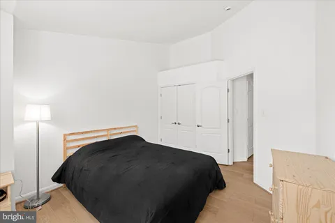 a bedroom with a bed and a lamp