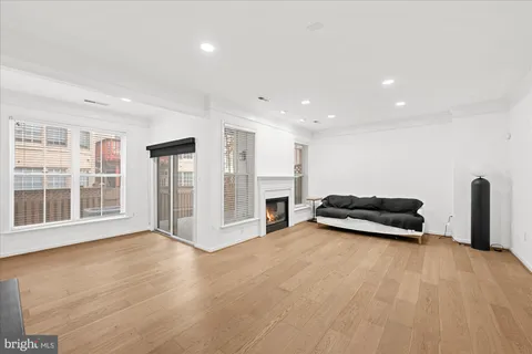 a view of a livingroom with furniture window and wooden floor