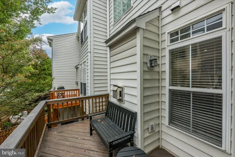 a view of balcony with wooden floor and fence