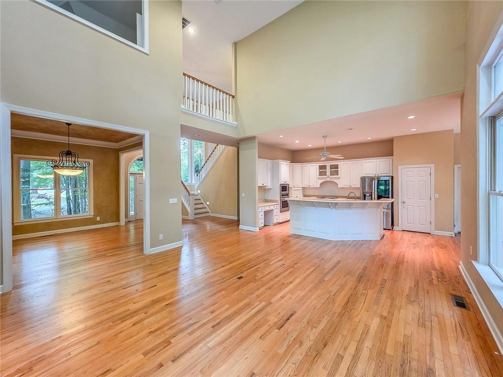 3712 Frederica Road Northwest Berkeley Lake, GA 30096 - Photo 13 of 49 a view of a living room with wooden floor and a kitchen