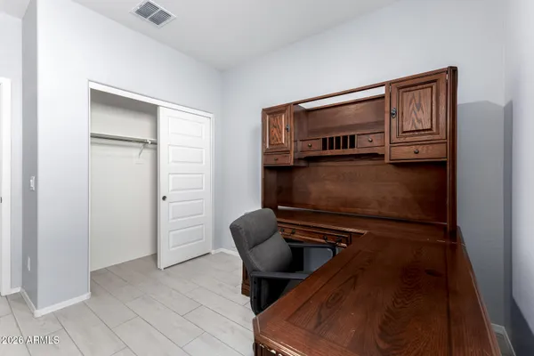 a living room with furniture and a air conditioner vent