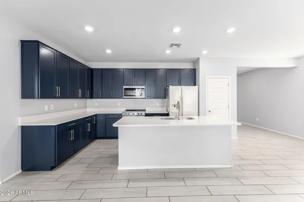 a large kitchen with stainless steel appliances lots of counter space sink and cabinets